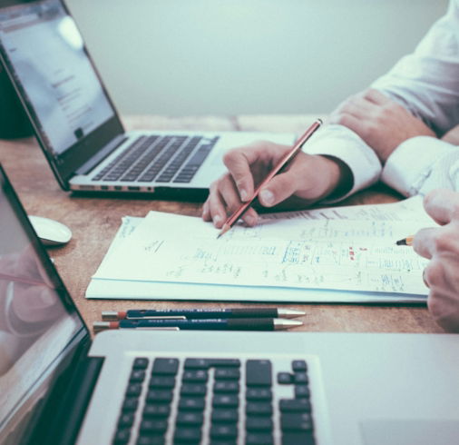 person-holding-pencil-near-laptop-computer.jpg person holding pencil near laptop computer